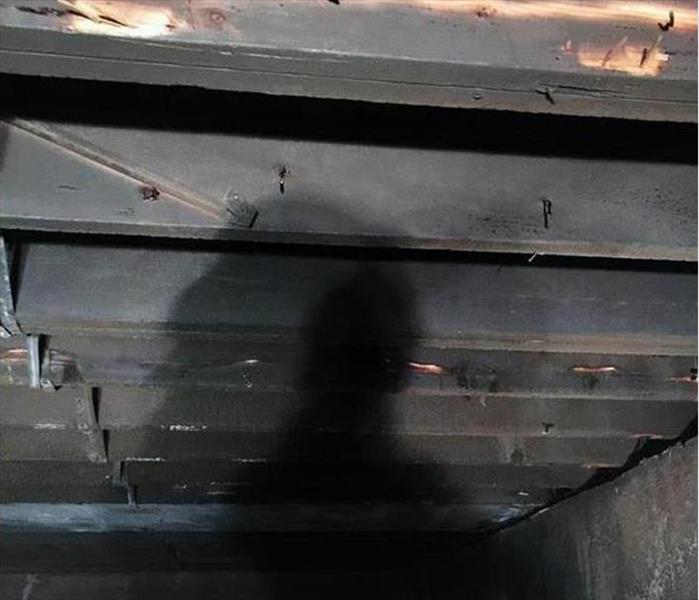 blackened raw roof supports from fire, thin film