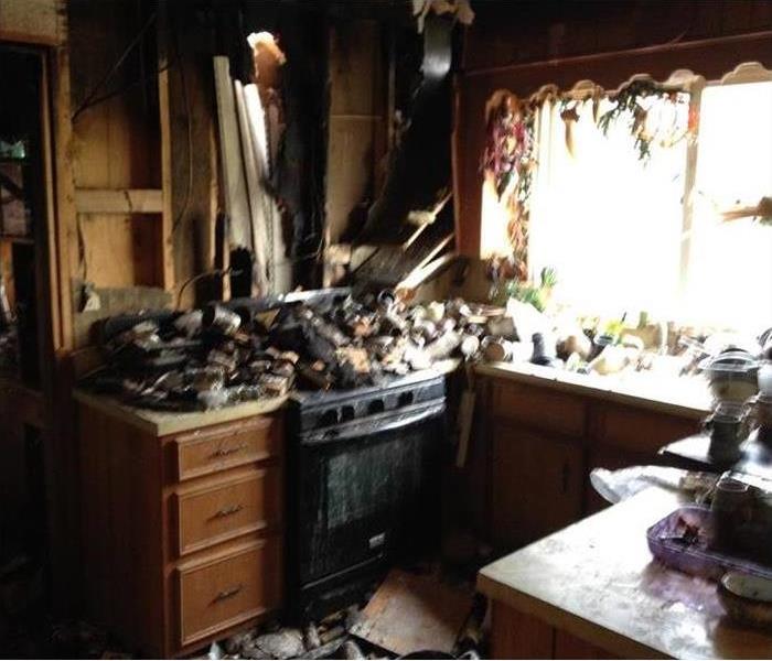burned badly kitchen, debris all over