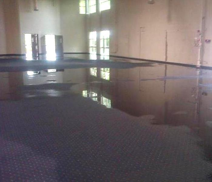water standing on carpet floor in large center