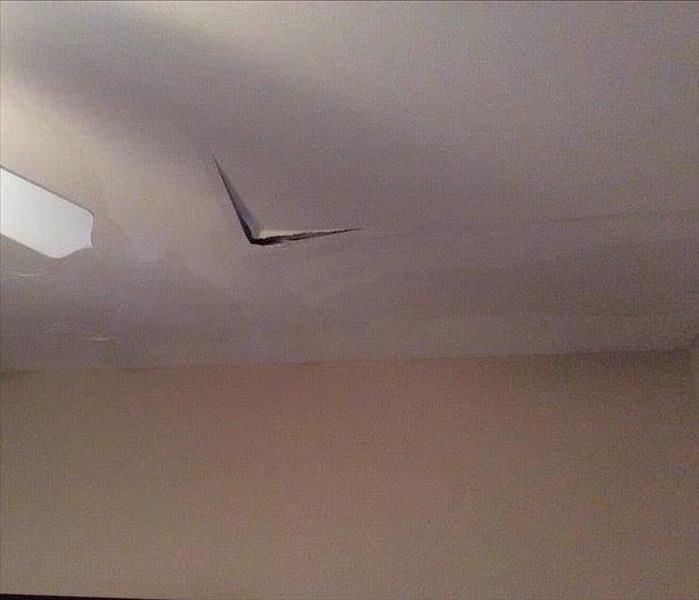 damaged ceiling, broken, ceiling fan blade visible and water stains