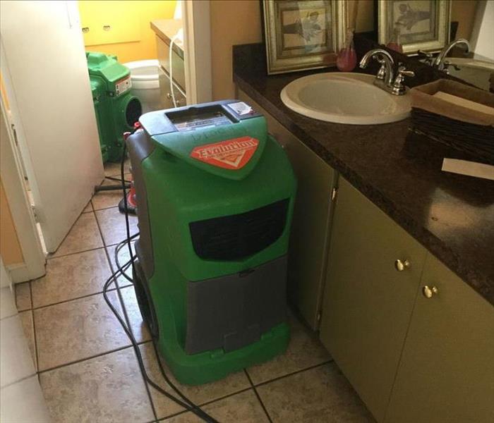 two dehumidifiers drying out a bathroom