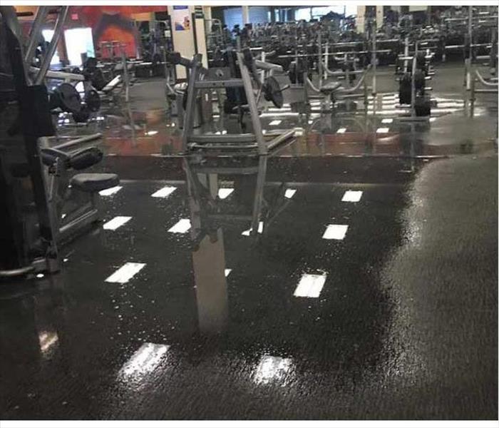 pooling water on gym floor, metal equipment 