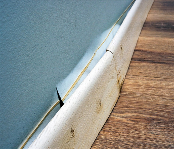 baseboards that have been warped from water damage