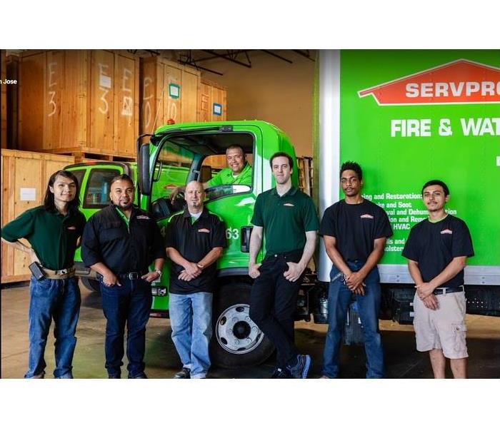 SERVPRO team members standing in front of SERVPRO truck