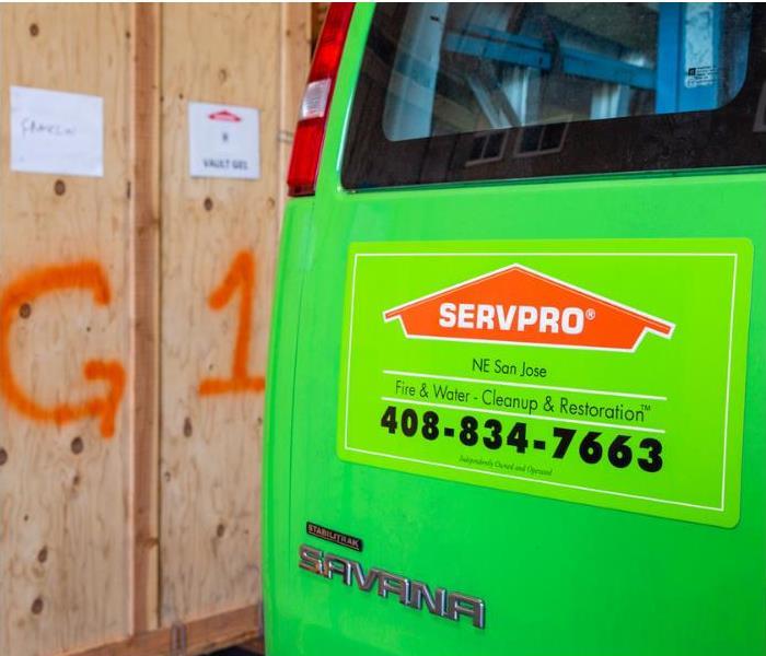 Back of a SERVPRO van by wooden boxes holding contents